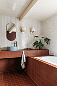 Bathroom with bathtub and red tiles, plant decor