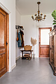 Entrance area with wooden doors, wardrobe and antique cupboard