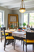 Set table in the dining room with antique door as decoration, country house style