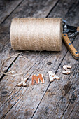 Jute string and letters 'XMAS' on a wooden table