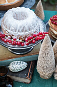 Christmas bundt cake with icing sugar and redcurrants
