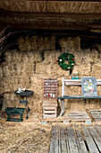 Barn with bales of straw, rustic furniture and Christmas decorations