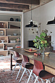 Dining room with rustic wooden table, chairs and terracotta tiles