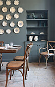 Dining room with blue-grey walls and wall plate decoration