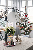 Christmas decorations with silver, lantern, small tree, poinsettia and decorated branch