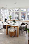 Winter garden dining room with sheepskin on chairs