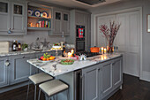 Modern grey kitchen with marble counter in atmospheric candlelight