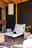 Cozy terrace with deckchair, cat and flowers