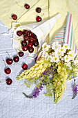 Flowers and cherries in lacy bags made from homemade oilcloths
