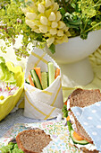 Summer picnic with homemade sandwiches and fresh vegetable sticks