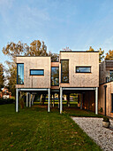 Modern wooden house on stilts in a spacious garden