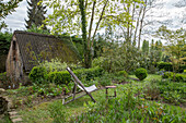 Garden with deckchair next to old shed