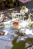 Springtime table decorations with cake and macarons in the garden