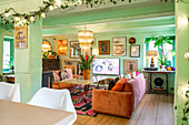 Living room with Caribbean flair, green walls and vintage décor