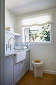 Kitchen area with marble worktop and window overlooking the greenery