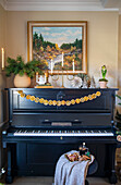 Antique piano with candlestick and garland of dried oranges
