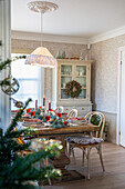 Festively laid dining table with Christmas decorations and candlelight