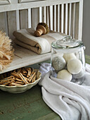 Storage jar with dryer balls, wooden clothes pegs, wooden brush and linen cloth