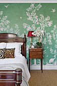 Antique bedroom with green wallpaper and floral patterns