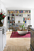 Reading corner in the living room with zebra armchairs, bookshelf and oriental rug