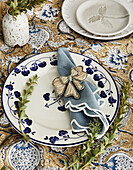 Table setting with floral porcelain plate and embroidered napkin