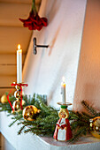 Fireplace decorated for Christmas with candle angels and fir branches