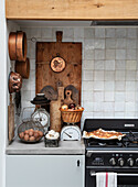 Country-style kitchen with rustic kitchen utensils and apple pie on a gas hob
