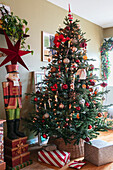 Weihnachtlicher Wohnraum mit geschmücktem Tannenbaum und Nussknacker-Figur