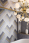 Mosaic tiles in a geometric pattern and ball light in the bathroom