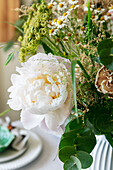 Bouquet with peony (Paeonia), camomile and eucalyptus