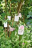 DIY garden plug made from tin cans and branches placed in the garden