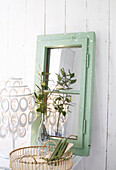 Upcycling: Old window sash in green with white splashes of colour as a mirror, decoration on a light chest of drawers