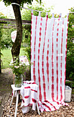 Batik curtain next to floral decoration in the summer garden
