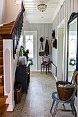 Inviting hallway with patterned tiles and wooden plank staircase
