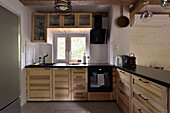 Wooden kitchen with modern appliances and black details