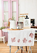 Table runner with leaf print on small indoor table