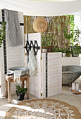 DIY screen in front of bathtub, wash bowl and plants, boho style