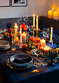 Autumnal table setting with pumpkins and candlelight