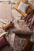 Various patterned carpets and cushions on wooden floors