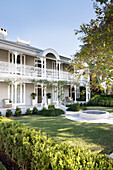 Historic villa with ornate balconies and manicured garden