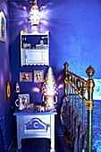 Metal bed and bedside table in blue, oriental bedroom