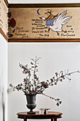 Historic wall painting with flower arrangement on wooden table