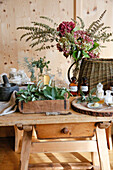 Antique wooden table with mortar, fresh sage and ingredients for natural cosmetics