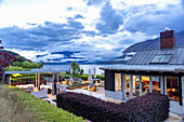 Modern terrace with cosy seating area and lake view at dusk