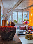 Cosy living room with candlelight and colourful cushions on the sofa