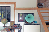 Work area with globe, antique sewing machine and light blue gramophone
