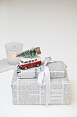 Gifts in newspaper with bus decoration and miniature Christmas tree