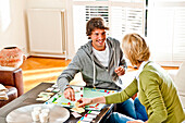 Young couple playing monopoly, Hamburg, Germany