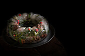  Christmas decoration with ice ring filled with holly, cones and needles 