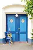  Old blue front door and chair as decoration 